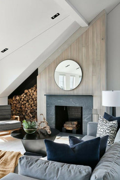 Round mirror over fireplace